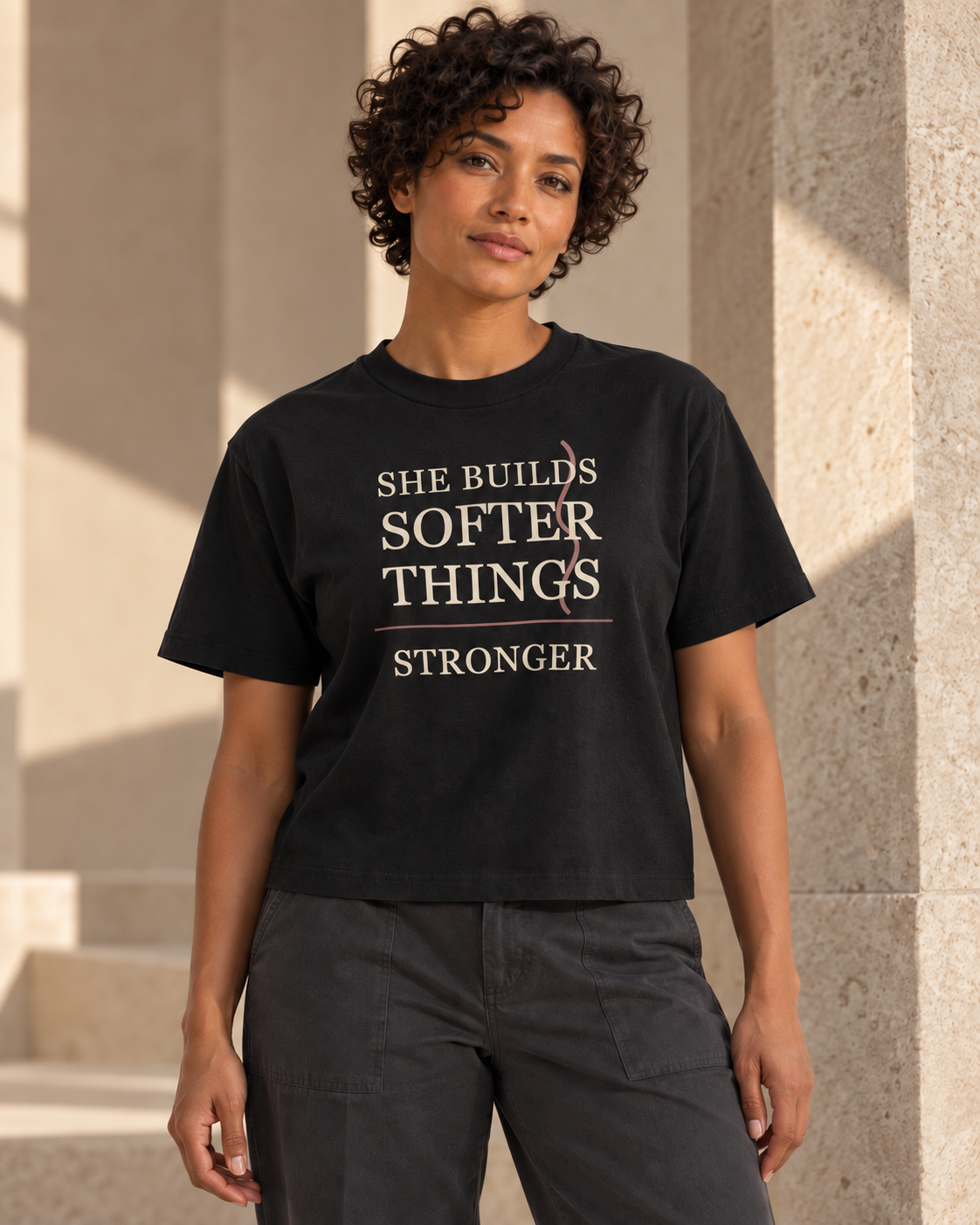 Digital visualization: woman wearing the black Softer Things boxy tee with cream-and-mauve front graphic