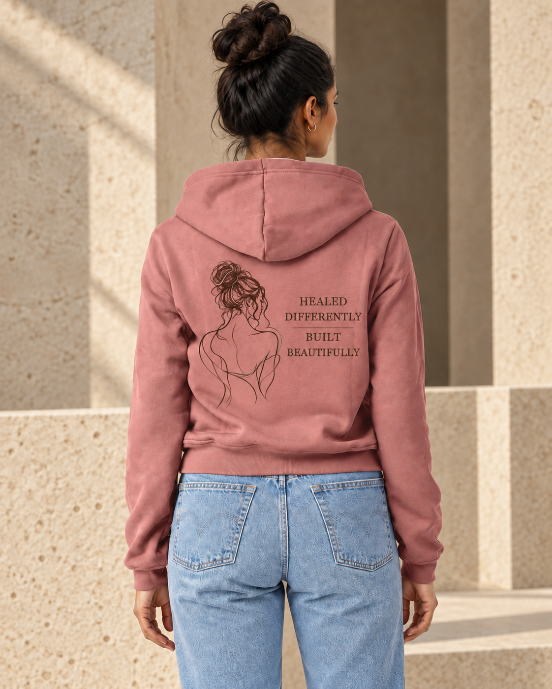 Digital design visualization of a woman wearing CALLED FORM Healed Differently Hoodie in Mauve, showing the back artwork.